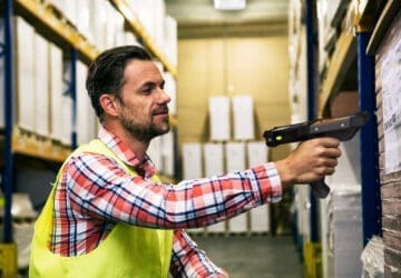 image of a warehouse worker with handheld computer value of zebra onecare