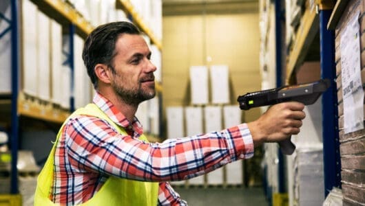 image of a warehouse worker with handheld computer value of zebra onecare